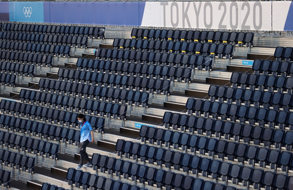 July 19, 2021 A volunteer walks in a stand REUTERS/Edgar Su