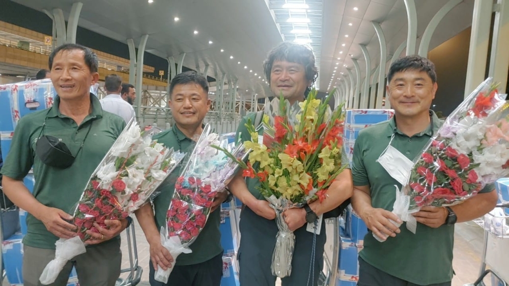 South Korean climber Kim Hong-Bin (2nd R) along with team members hold bouquets at the airport in Islamabad, Pakistan June 16, 2021. Picture taken June 16, 2021. Karrar Haidri/Alpine Club of Pakistan/Handout via REUTERS