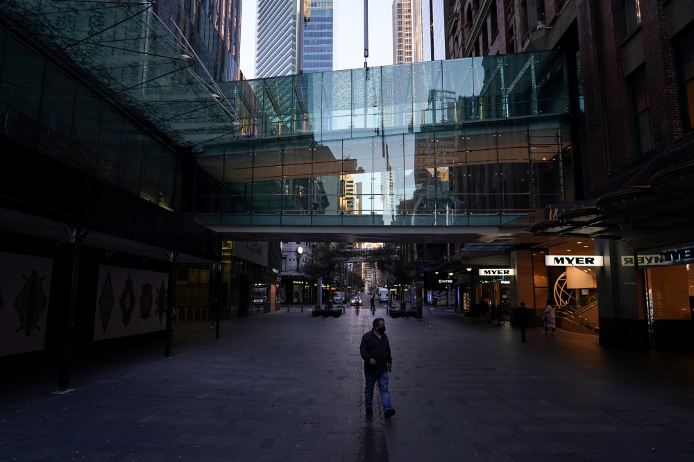 A man wears a protective face mask at the unusually quiet Pitt Street Mall in the City Centre during a lockdown to curb the spread of the coronavirus disease (COVID-19) outbreak in Sydney, Australia, July 21, 2021. REUTERS/Loren Elliott