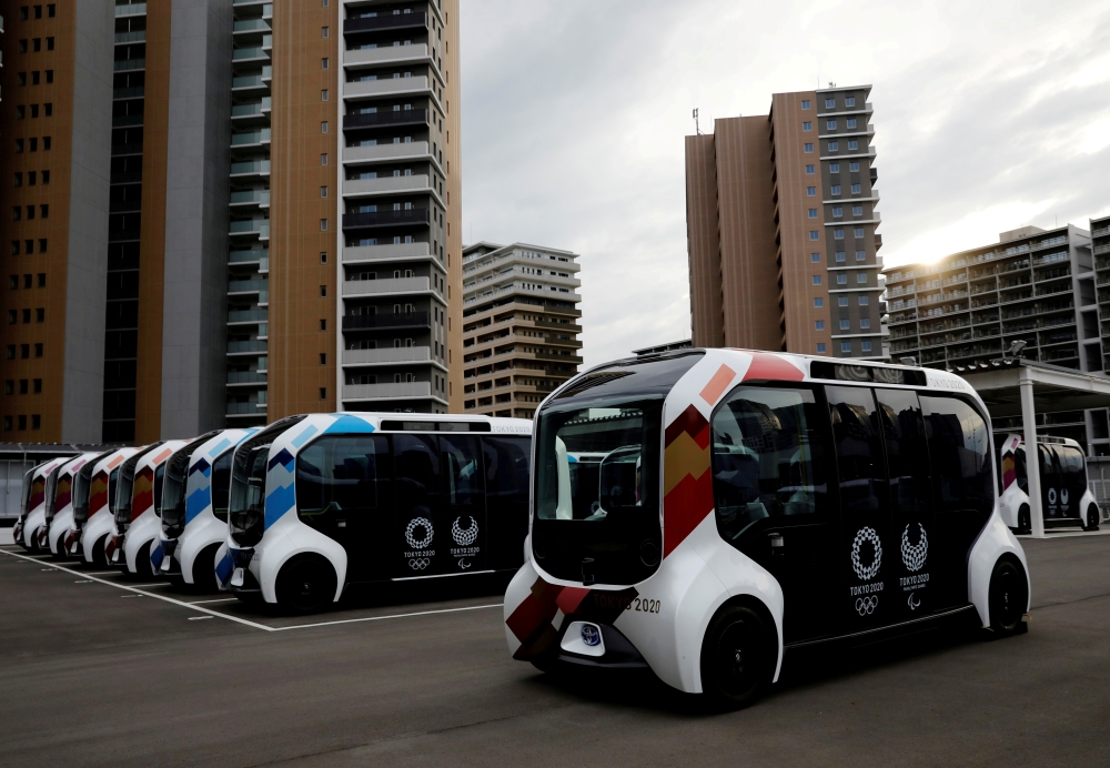 Electric vehicles are pictured at an internal shuttle bus station of the Tokyo 2020 Olympic and Paralympic Village in Tokyo, Japan, June 20, 2021. REUTERS/Kim Kyung-Hoon/File Photo