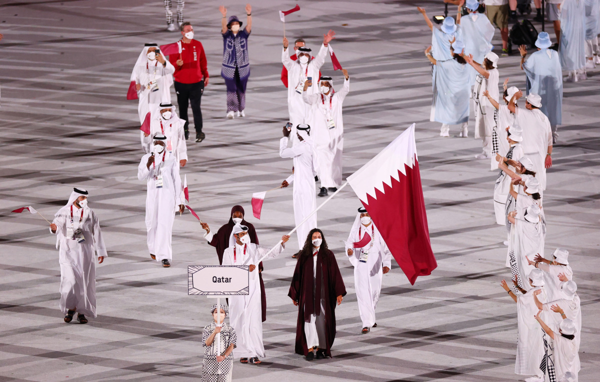 Flag bearers Tala Abujbara and Mohammed Al Rumaihi of Qatar lead their contingent during the athletes parade at the opening ceremony of the Olympics at the Olympic Stadium in Tokyo, Japan, yesterday.