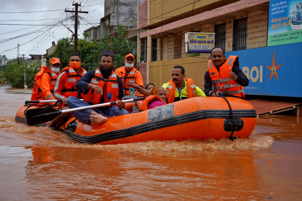 Members of National Disaster Response Force (NDRF) evacuate people from a flooded area to safer places in Kolhapur in the western state of Maharashtra, India, July 24, 2021. REUTERS/Abhijeet Gurjar