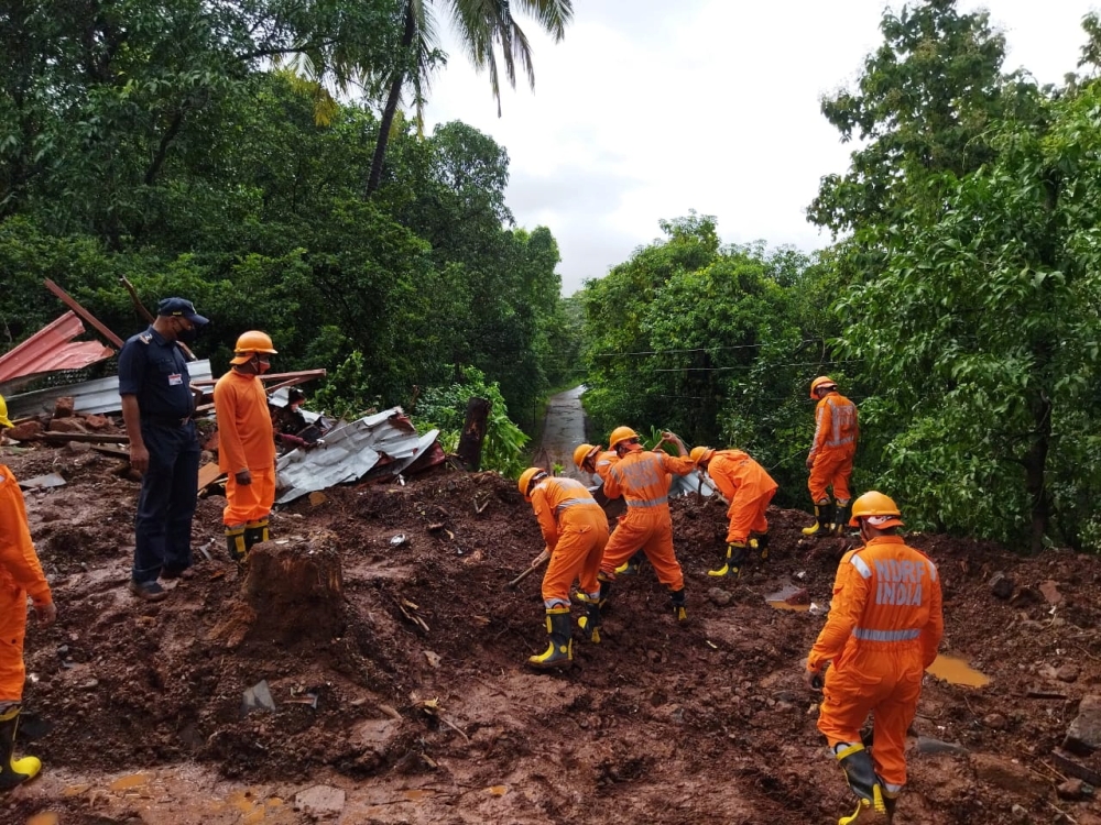 Members of National Disaster Response Force (NDRF) conduct a search and rescue operation after a landslide following heavy rains in Ratnagiri district, Maharashtra state, India, July 25, 2021. National Disaster Response Force/Handout via REUTERS