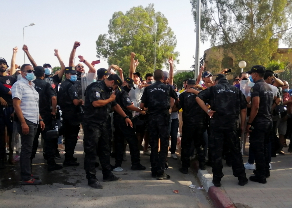 Police officers stand guard as supporters of Tunisia's biggest political party gather outside the parliament building in Tunis, Tunisia July 26, 2021. Reuters/Jihed Abidellaoui