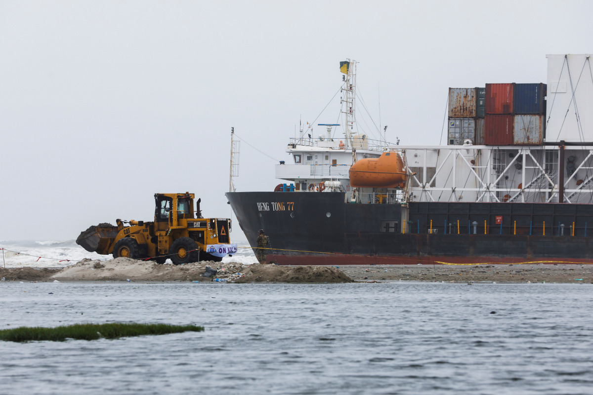 A wheel loader clears the ground near stranded cargo ship MV Heng Tong 77 at Sea View beach in Karachi, Pakistan July 26, 2021. REUTERS/Akhtar Soomro
