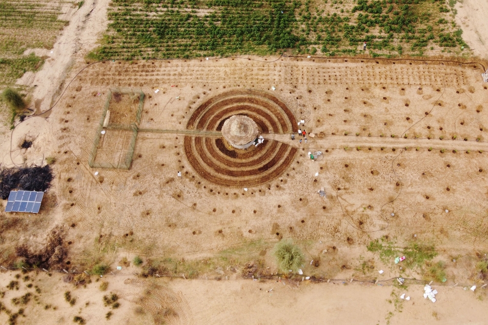 An aerial view shows participants of a Tolou Keur programme working on a newly built Tolou Keur garden in Boki Diawe, within the Great Green Wall area, in Matam region, Senegal, July 10, 2021. Picture taken with a drone. REUTERS/Zohra Bensemra