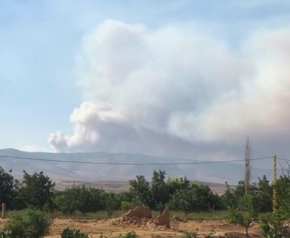 A plume of smoke billows over Qobayat, as seen from Kaa, Lebanon July 28, 2021 in this still image taken from social media video.Tony Tom /via REUTERS