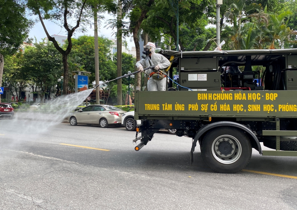 Military personnel spray disinfectant on the streets during a lockdown designed to curb the spread of COVID-19 in Hanoi, Vietnam, on July 26, 2021. REUTERS/Stringer/File Photo