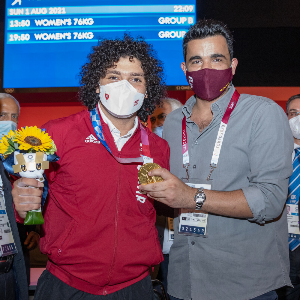 Qatar Olympic Committee (QOC) President Sheikh Joaan bin Hamad Al Thani, poses for a photograph with Fares Ibrahim after the Qatari weightlifter win the country's first ever Olympic gold medal.