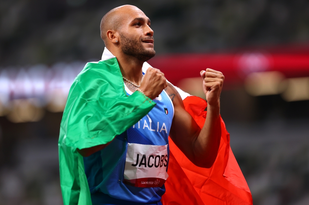 Lamont Marcell Jacobs of Italy celebrates after winning gold REUTERS/Andrew Boyers