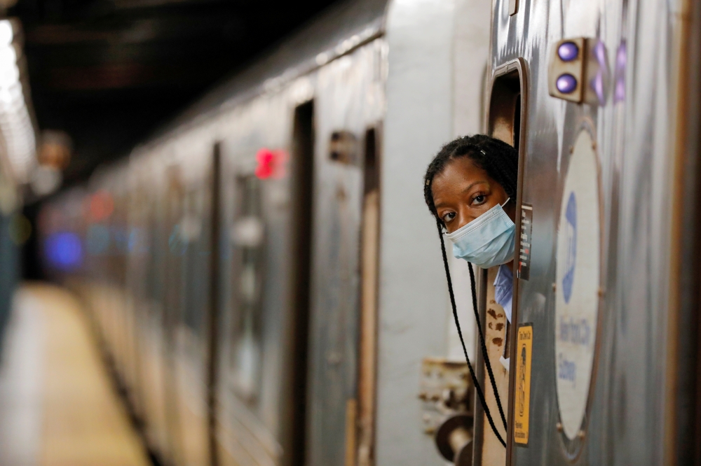 An MTA worker is seen wearing a mask on the subway after The Port Authority of New York and New Jersey and the Metropolitan Transportation Authority (MTA) announced a mandatory coronavirus vaccination or weekly test mandate for employees in New York City,