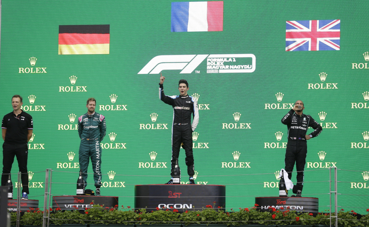 Formula One F1 - Hungarian Grand Prix - Hungaroring, Budapest, Hungary - August 1, 2021 Second placed Sebastian Vettel of Aston Martin, first placed Esteban Ocon of Alpine and third placed Lewis Hamilton of Mercedes on the podium after the race REUTERS/Da