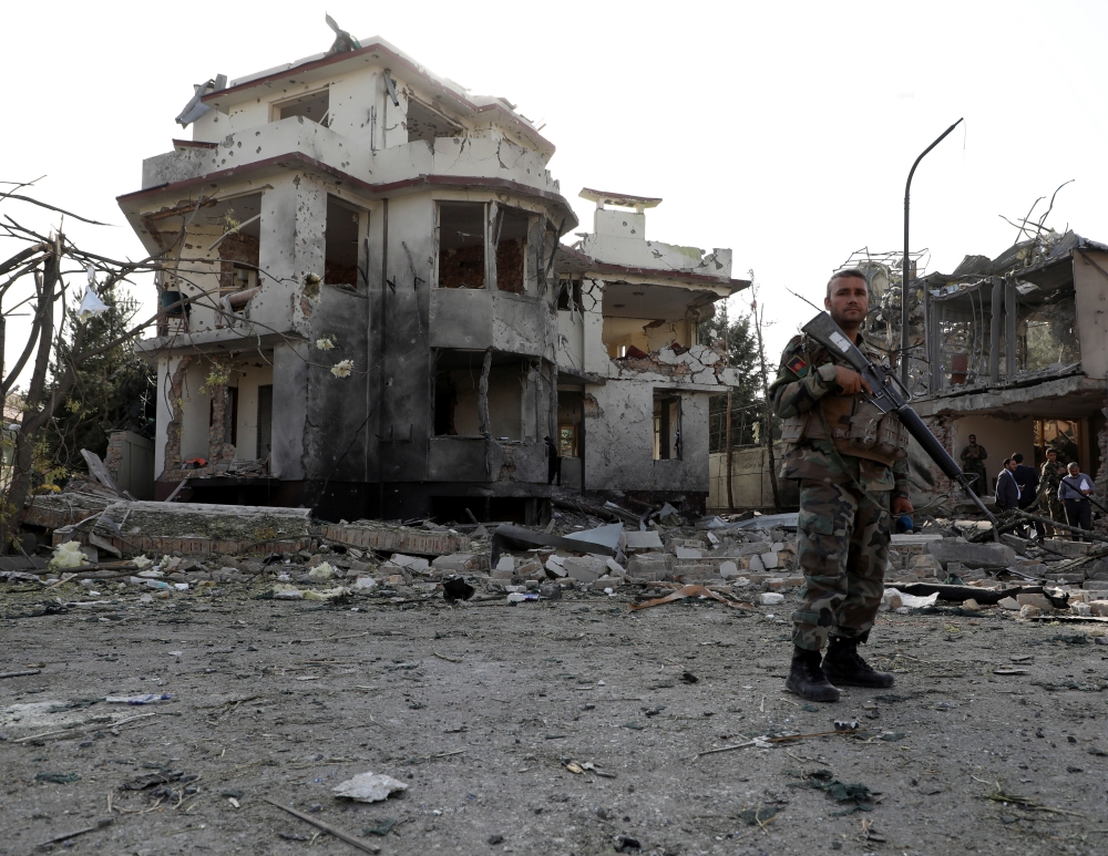 An Afghan National Army (ANA) soldier keeps watch at the site of yesterday's night-time car bomb blast in Kabul, Afghanistan August 4, 2021. REUTERS/Stringer
