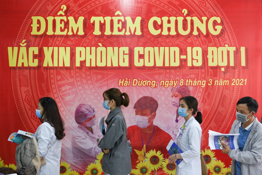 Health workers wait for their turn as Vietnam starts its official rollout of AstraZeneca's coronavirus disease (COVID-19) vaccine for health workers, at Hai Duong Hospital for Tropical Diseases, Hai Duong province, Vietnam, March 8, 2021. REUTERS/Thanh Hu