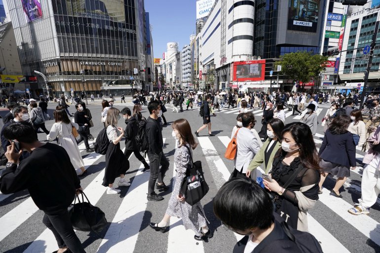 Passersby wearing protective face masks walk on Shibuya crossing amid the coronavirus disease (COVID-19) outbreak in Tokyo, Japan April 23, 2021, in this photo taken by Kyodo.