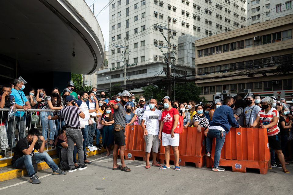 Filipinos waiting to be vaccinated against the coronavirus disease (COVID-19) gather outside a mall, a day before stricter lockdown measures are implemented, in Manila, Philippines, August 5, 2021. REUTERS/Lisa Marie David



