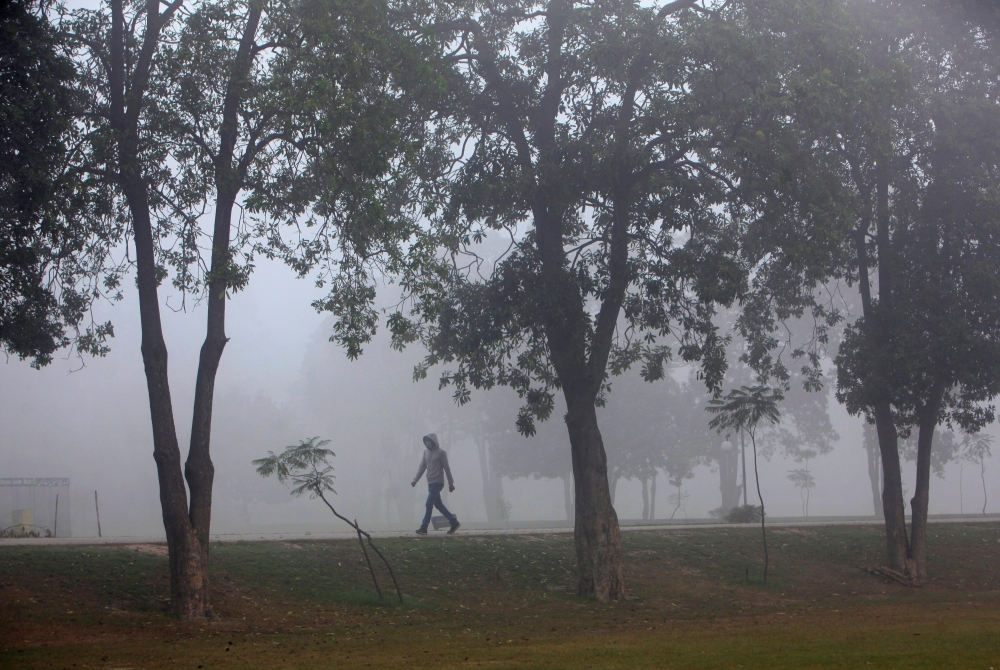 Man walks through a thick layer of smog in Pakistan. File photo for representational purposes only.