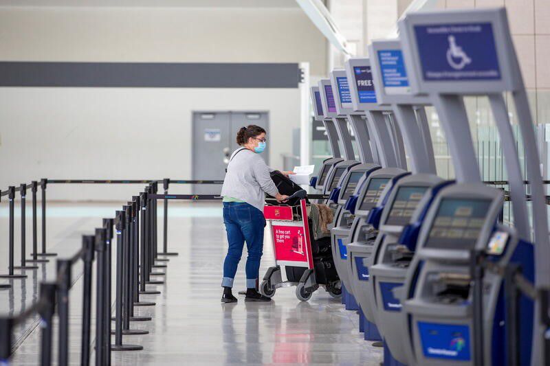 A person wearing a protective mask walks through terminal 1 at Toronto's Pearson Airport after mandatory coronavirus disease (COVID-19) testing took effect for international arrivals in Mississauga, Ontario, Canada February 15, 2021. REUTERS/Carlos Osorio