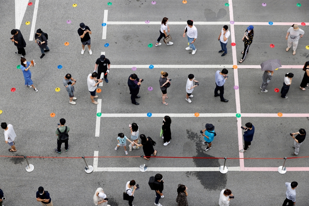 People wait in line for a coronavirus disease (COVID-19) test at a testing site which is temporarily set up at a public health center in Seoul, South Korea, July 9, 2021. REUTERS/ Heo Ran/File Photo