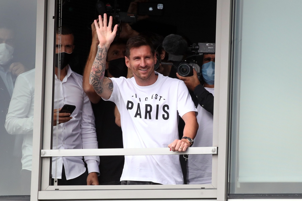 August 10, 2021 Lionel Messi waves as he arrives in Paris REUTERS/Yves Herman
