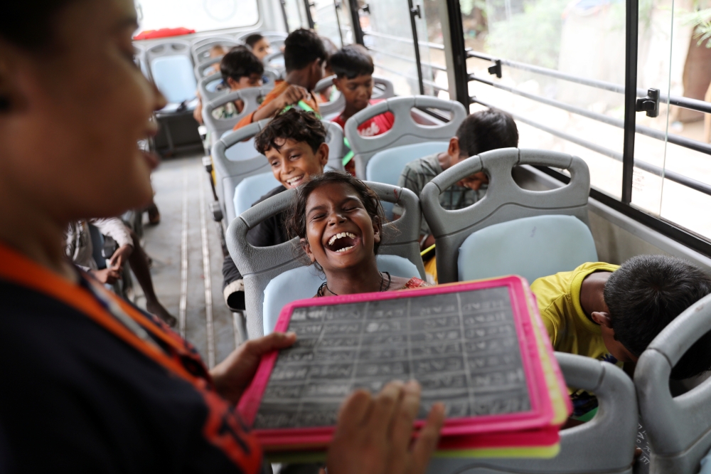Gauri, 8, reacts inside a parked bus run by TejasAsia, an NGO using 