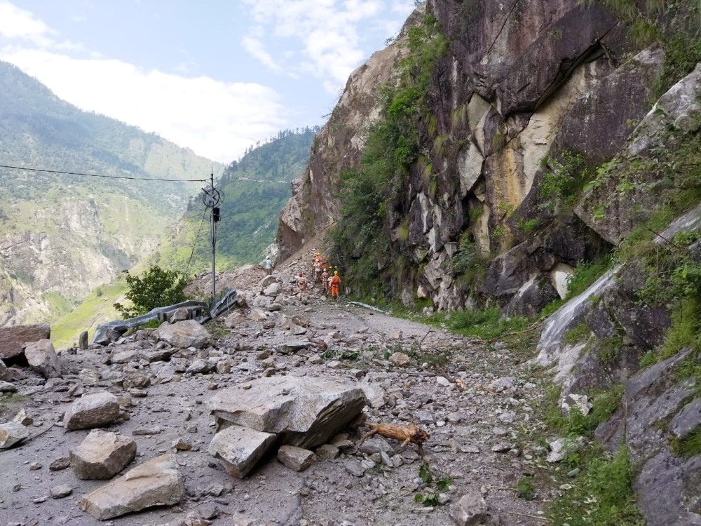 Members of the National Disaster Response Force (NDRF) search for survivors during a rescue operation at the site of a landslide in Kinnaur district in the northern state of Himachal Pradesh, India, August 11, 2021. National Disaster Response Force/Handou