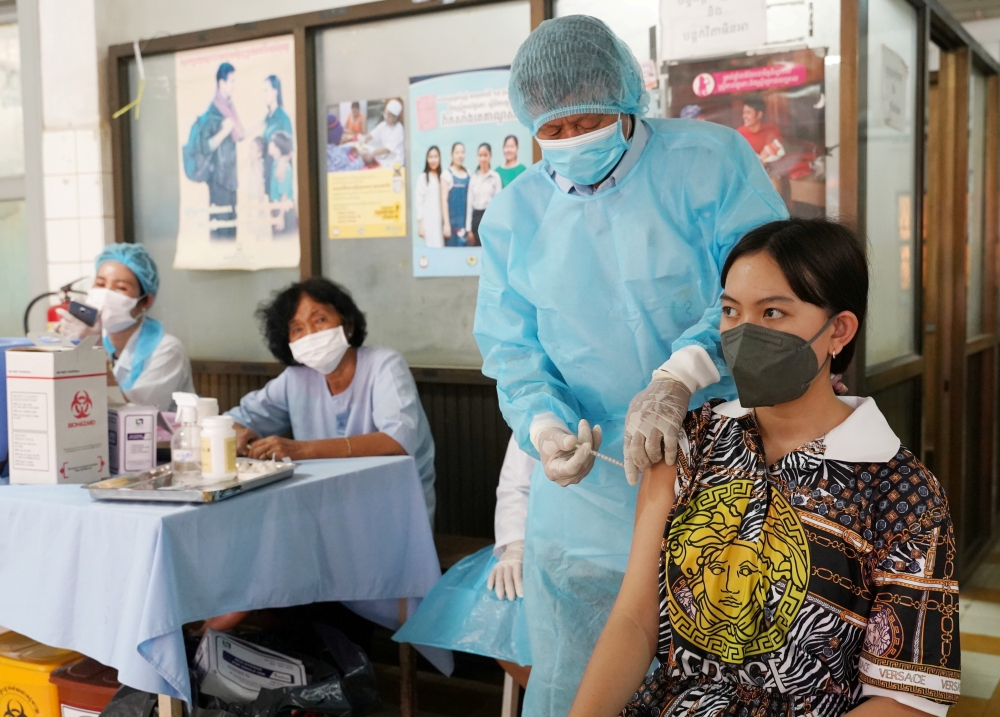A teenager receives a vaccine dose against the coronavirus disease (COVID-19) at a health center as Cambodia begins its vaccination campaign for ages 12 to 17, in Phnom Penh, Cambodia, August, 1, 2021. REUTERS/Cindy Liu/File Photo