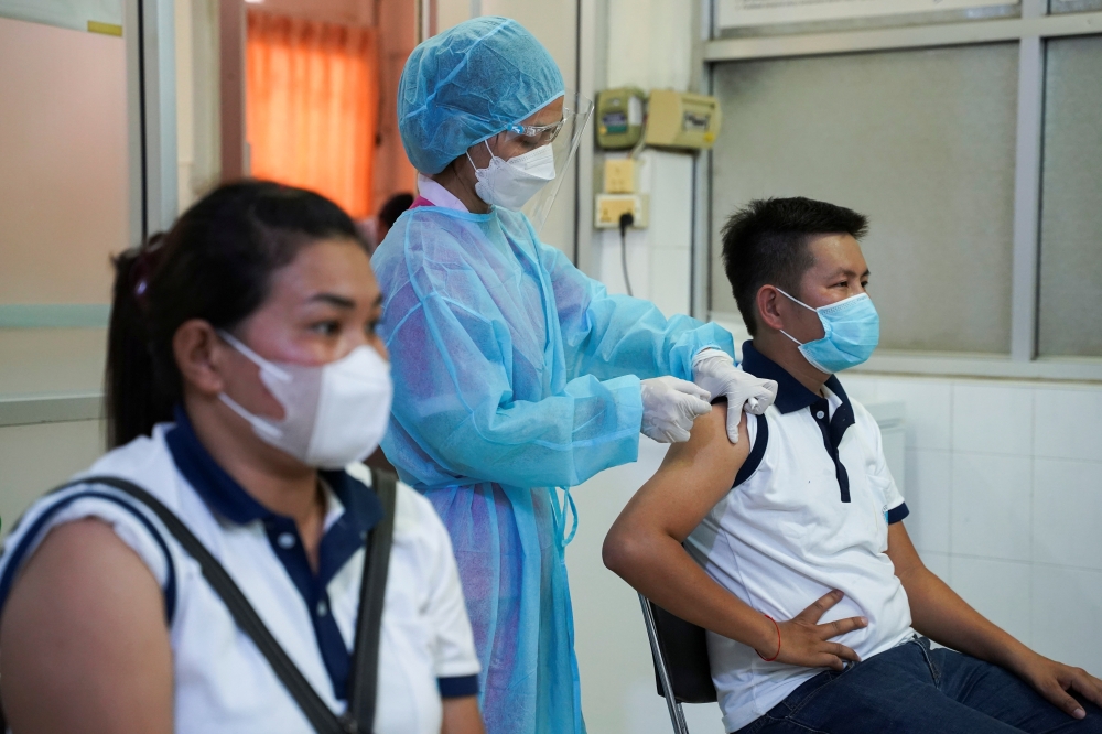 People receive an AstraZeneca coronavirus disease (COVID-19) vaccine as a booster dose at the National Pediatric Hospital in Phnom Penh, Cambodia, August 12, 2021.REUTERS/Cindy Liu