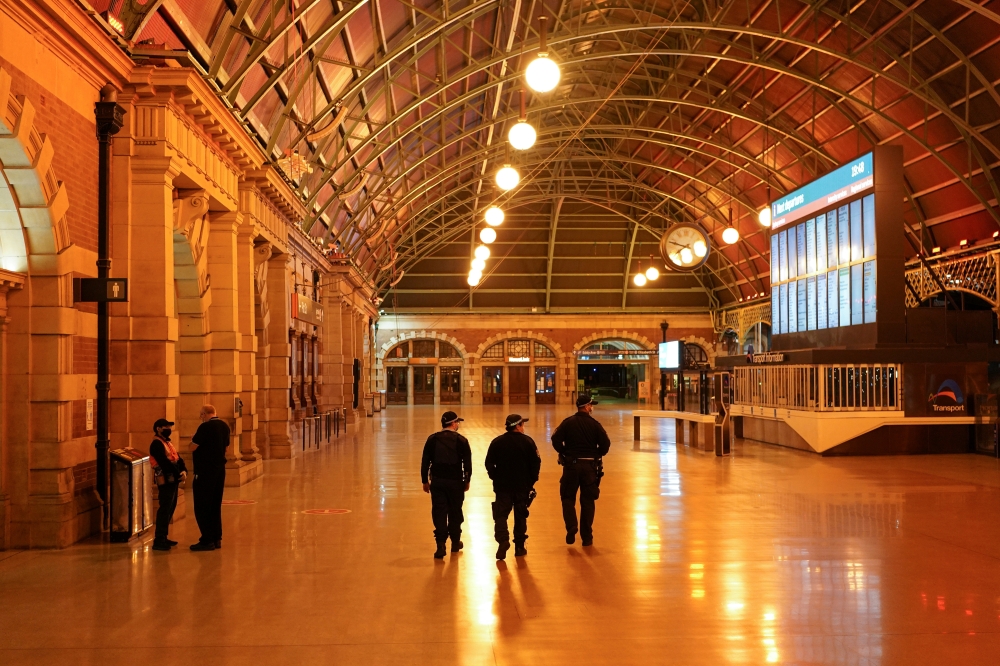 Police officers patrol through the quiet Central Station in the city centre during a lockdown to curb the spread of a coronavirus disease (COVID-19) outbreak in Sydney, Australia, August 12, 2021. REUTERS/Loren Elliott