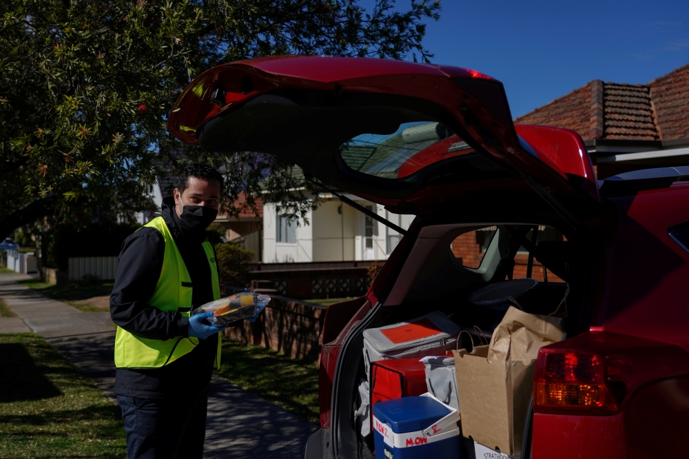 Bilal El-Hayek, a local government councillor and community leader, volunteers with Meals on Wheels to deliver food to members of vulnerable communities during a lockdown to curb the spread of a coronavirus disease (COVID-19) outbreak in the Canterbury-Ba