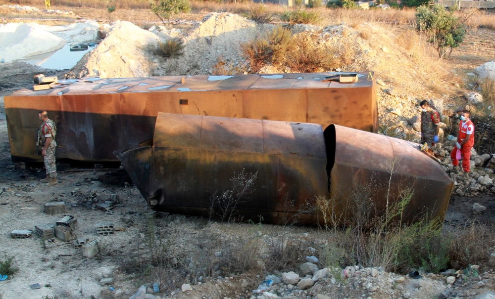 Lebanese army soldiers stand guard at the site of a fuel tank explosion in Akkar, in northern Lebanon, August 15, 2021. REUTERS/Omar Ibrahim