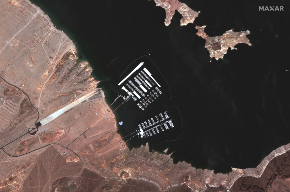 An aerial view shows the Hemenway Harbor boat launch area on Lake Mead and Hoover Dam on the Colorado River, U.S. May 18, 2020. SATELLITE IMAGE 2021 MAXAR TECHNOLOGIES/Handout via REUTERS