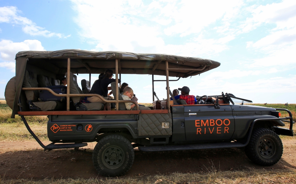 Gladys Kisemei, a tour guide at the Emboo River Camp drives tourists from the Ol Kiombo airstrip using an electric-powered safari vehicle at the Maasai Mara National Reserve in Narok County, Kenya July 16, 2021. Picture taken July 16, 2021. REUTERS/Monica