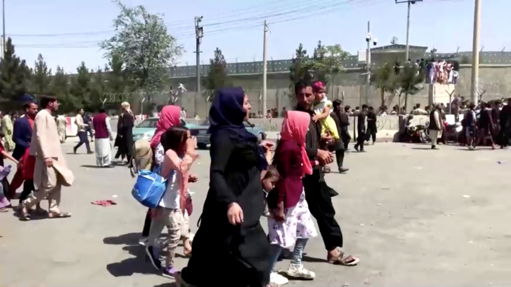 People gather outside Kabul airport, Afghanistan August 16, 2021, in this still image taken from a video. Reuters TV/via Reuters