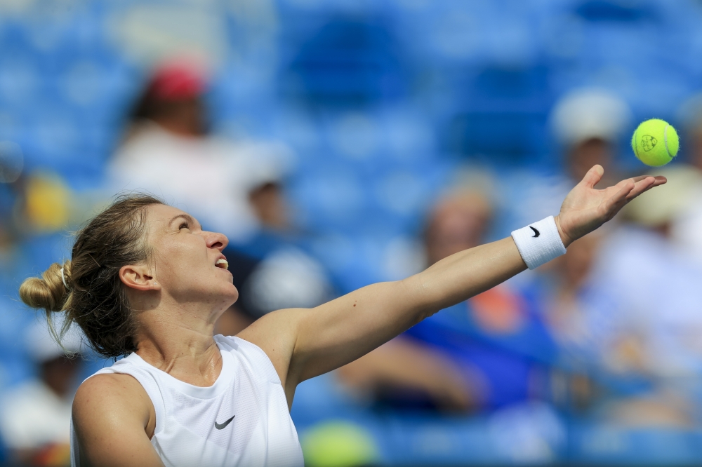 Simona Halep (ROU) serves the ball against Magda Linette (POL) during the Western and Southern Open tennis tournament at Lindner Family Tennis Center. Aaron Doster-USA TODAY Sports