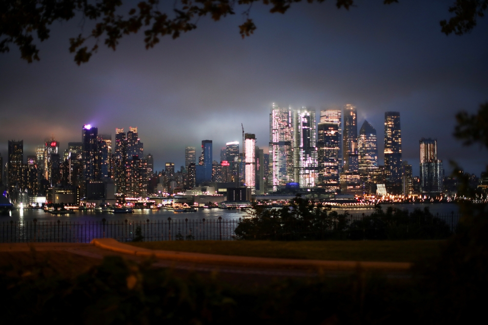 Clouds pass over middle Manhattan and the Empire State Building as Tropical Storm Henri passes through New York City, as seen from Weehawken's Hamilton Park in New Jersey, U.S., August 18, 2021. REUTERS/Eduardo Munoz
