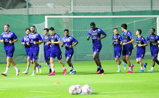 Al Duhail players warm up during a training session.