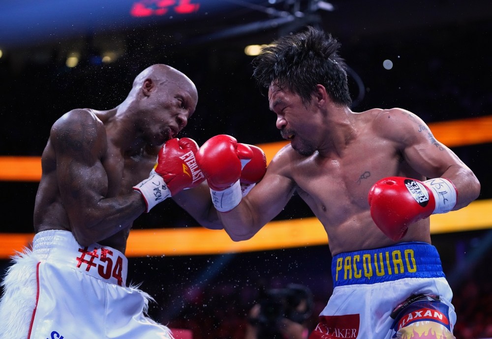 Manny Pacquiao (right) fights Yordenis Ugas in a world welterweight championship bout at T-Mobile Arena. Stephen R. Sylvanie-USA TODAY Sports