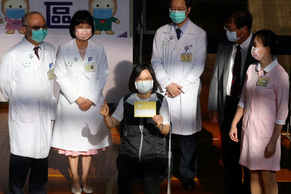 Taiwan President Tsai Ing-wen poses with her vaccination record after receiving a dose of Medigen Vaccine Biologics Corp's coronavirus disease (COVID-19) vaccine, a domestically developed vaccine against the disease, at National Taiwan University Hospital