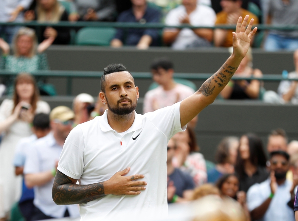 Australia's Nick Kyrgios waves to the spectators after losing his match by a walkover as he sustained an injury Reuters/Peter Nicholls/File Photo