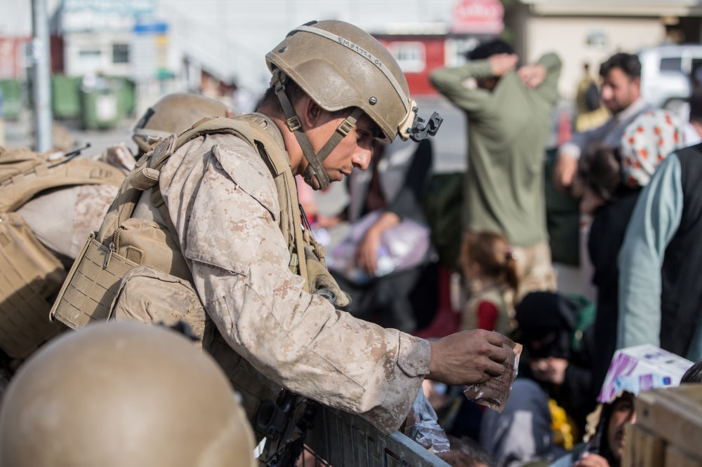 A US Marine opens a meal ready-to-eat for children to eat during an evacuation at Hamid Karzai International Airport, Kabul, Afghanistan. US Marine Corps/Sgt. Samuel Ruiz/Handout via Reuters