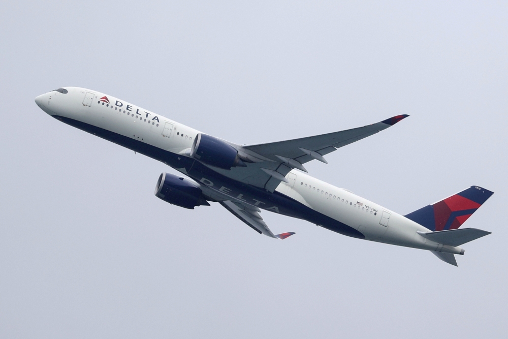 FILE PHOTO: A Delta Air Lines Airbus A350-900 plane takes off from Sydney Airport in Sydney, Australia, October 28, 2020. REUTERS/Loren Elliott/File Photo
