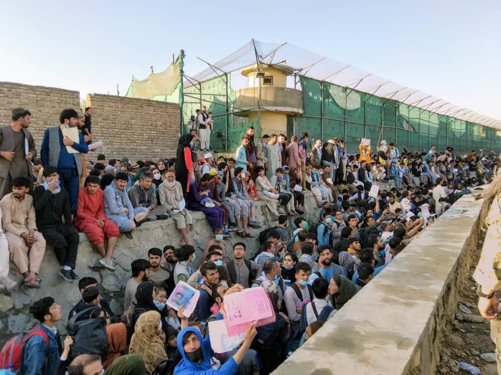 Crowds of people wait outside the airport in Kabul, Afghanistan August 25, 2021 in this picture obtained from social media. Twitter/DAVID_MARTINON via REUTERS 