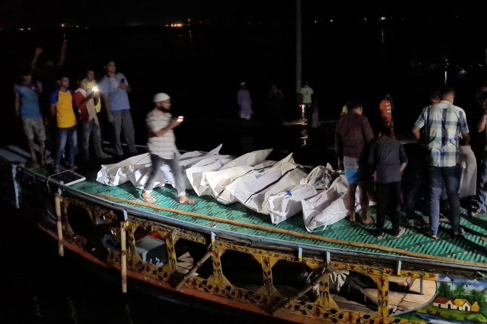 Recovered bodies are seen after a boat packed with passengers slammed into a vessel transporting sand, in Brahmanbaria, Bangladesh August 27, 2021. REUTERS/Stringer