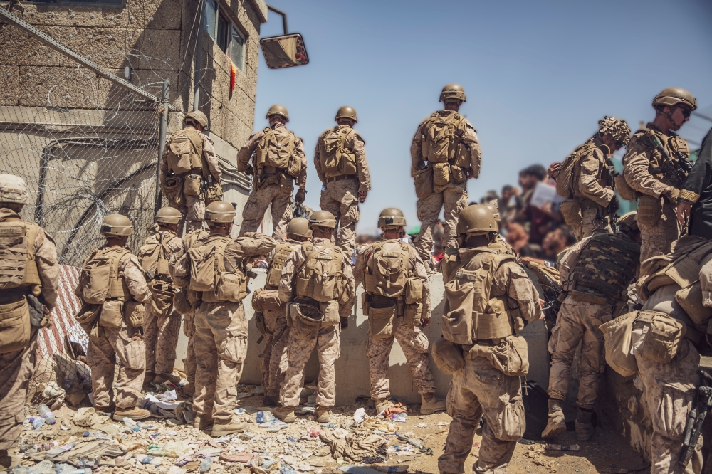 U.S. Marines with Special Purpose Marine Air-Ground Task Force - Crisis Response - Central Command assist with security at an Evacuation Control Checkpoint (ECC) during an evacuation at Hamid Karzai International Airport, Kabul, Afghanistan, August 26, 20