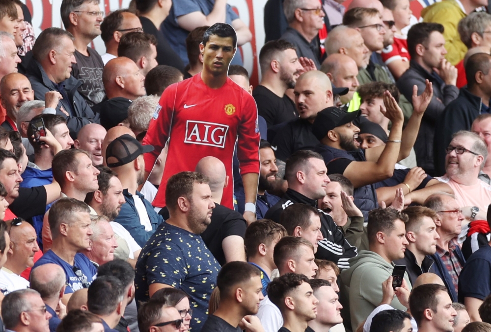 General view of Manchester United fans holding up a cardboard cut out of Cristiano Ronaldo Action Images via Reuters/Carl Recine 
