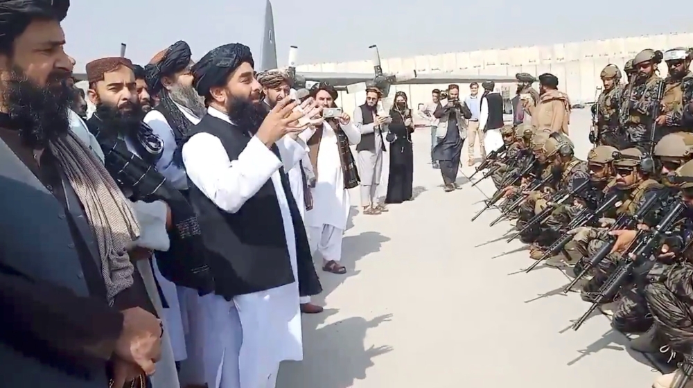 Taliban spokesman Zabihullah Mujahid speaks to Badri 313 military unit at Kabul's airport, Afghanistan August 31, 2021 in this still image obtained from a handout video. Taliban/Handout via Reuters 