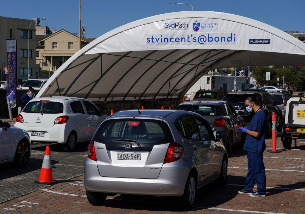 Medical workers speak with members of the public at the Bondi Beach drive-through coronavirus disease (COVID-19) testing centre during a lockdown to curb the spread of an outbreak in Sydney, Australia, September 1, 2021. Reuters/Loren Elliott