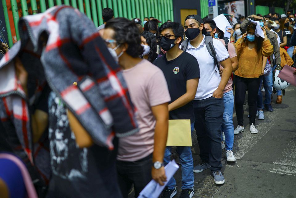 People line up to receive a dose of the Pfizer vaccine against the coronavirus disease (COVID-19) during a mass vaccination for people from 18 to 29 years old, in Xochimilco, on the outskirts of Mexico City, Mexico August 19, 2021. REUTERS/Edgard Garrido