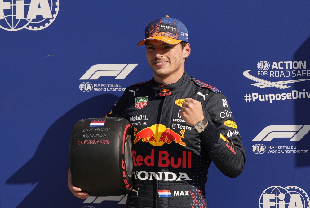 Red Bull's Max Verstappen poses with a tire after qualifying in pole position Pool via REUTERS/Francisco Seco